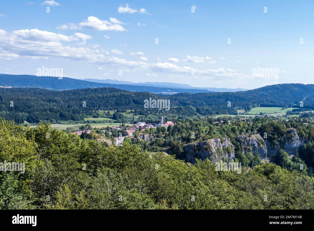 La Chaux-du-Dombief (central-eastern France): overview of the village, the forest and the Jura mountains from the “Pic de l’Aigle” peak Stock Photo