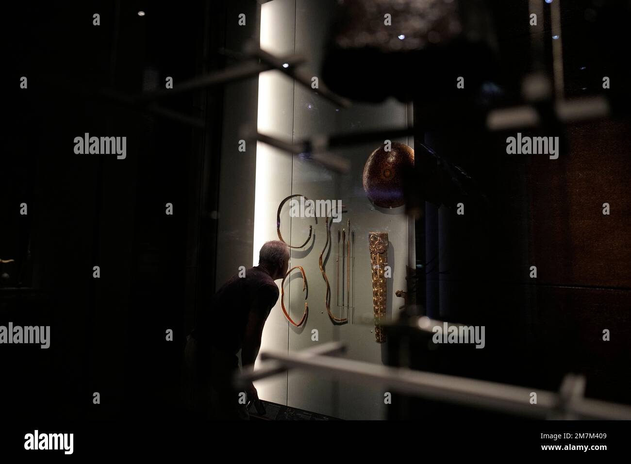 A man looks at bow and arrows at the Museum of Islamic Art in Doha