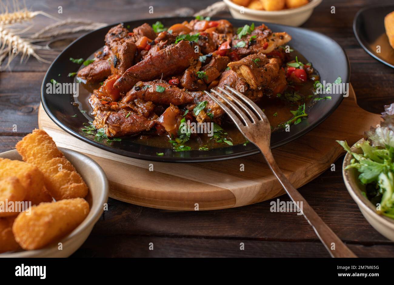 African chicken stew or curry with spicy vegetables on wooden table Stock Photo