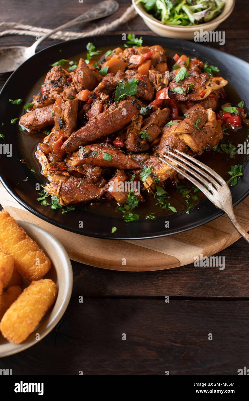 Stew chicken marinated with harissa sauce and cooked with vegetables. Stock Photo