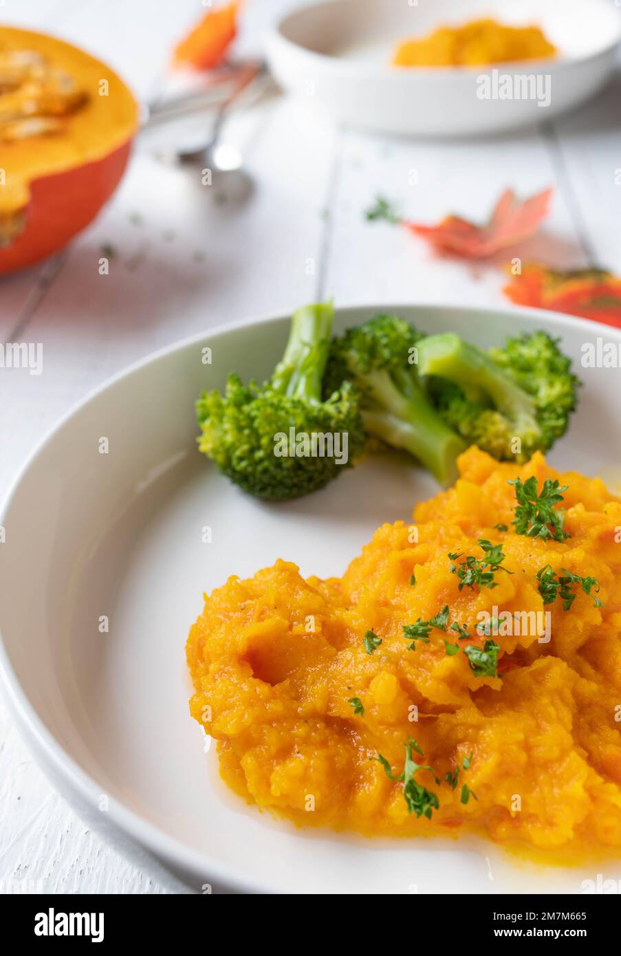 Fitness food side dishes for dinner or lunch with pumpkin puree and broccoli on a plate Stock Photo