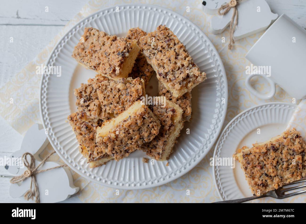 Nut cake with hazelnuts with easter decoration on white background. Flat lay Stock Photo