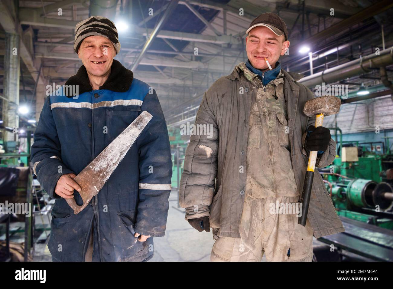 Two bad unskilled workers in bad dirty tattered uniform with bad