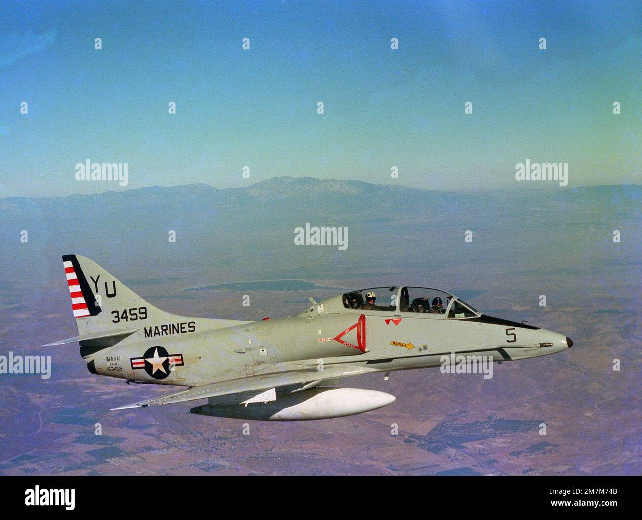 An air-to-air right side view of a TA-4F Skyhawk aircraft from Headquarters and Maintenance Squadron 13 (H&MS-13). (Substandard image). State: California (CA) Country: United States Of America (USA) Stock Photo