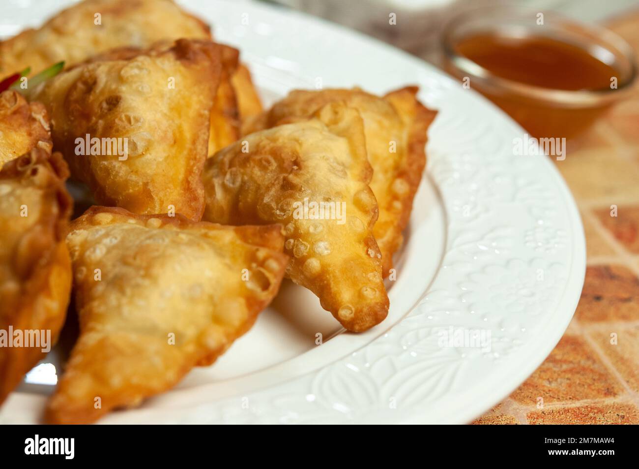 Chinese wontons with sweet chilli dip sauce and chop sticks. Asian fried dumplings with soy