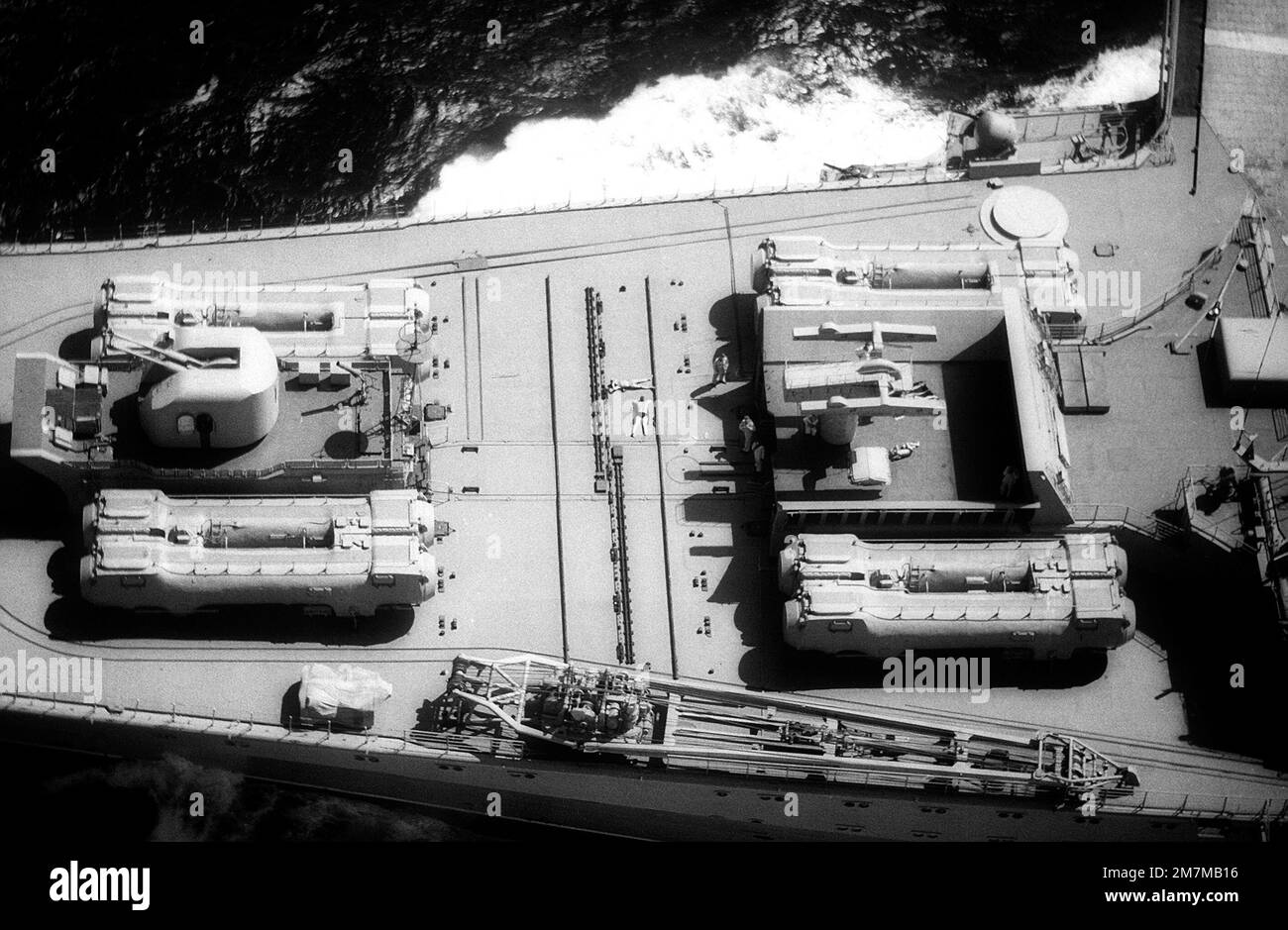 An elevated view of the bow of the Soviet aircraft carrier KIEV (CVHG) showing a 76.2mm/60-caliber anti-aircraft gun, eight SS-N-12 Shaddock missile launch tubes and an SA-N-3 missile launcher. A retracted SA-N-4 missile launcher is under the circular cover plate in the upper left. Country: Mediterranean Sea (MED) Stock Photo