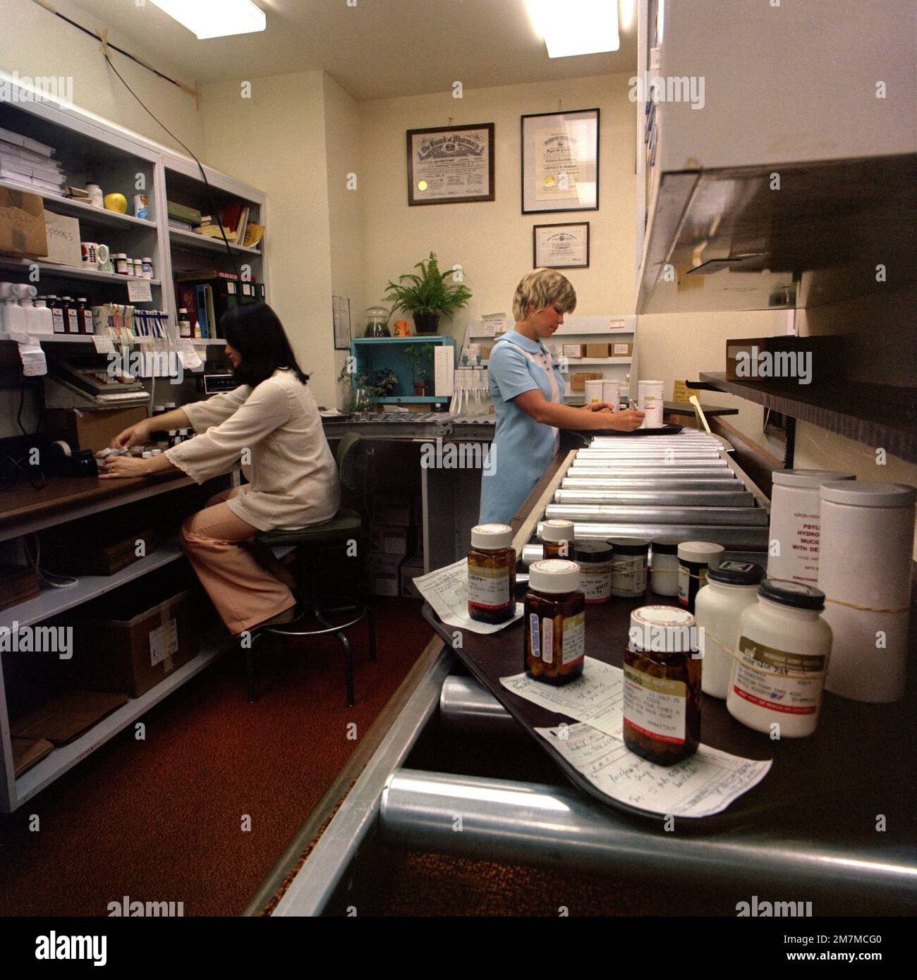 Betty H. Lyon and Myra C. Phillips, registered pharmacists, work the ...