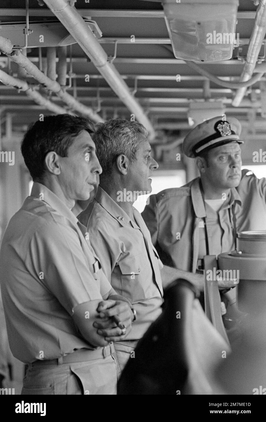 Rear Admiral Frederick F. Palmer, Commander, Amphibious Group Two, center, talks to crewmen on the bridge of the amphibious command ship USS MOUNT WHITNEY (LCC 20) while en route to participate in allied Exercise TEAM WORK '76. The MOUNT WHITNEY is serving as flagship during the exercise is scheduled for September 15-24. Subject Operation/Series: TEAM WORK '76 Country: Unknown Stock Photo