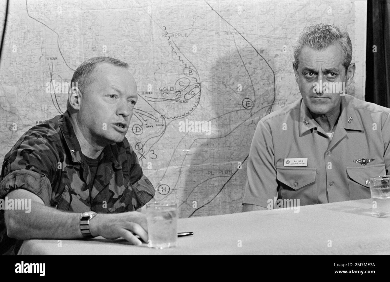 Rear Admiral Frederick F. Palmer, Commander, US Amphibious Group Two, and a Marine Brigadier General hold a briefing aboard the amphibious command ship USS MOUNT WHITNEY (LCC 20) while en route to participate in the allied Exercise TEAM WORK '76. The MOUNT WHITNEY is serving as flagship during the exercise scheduled for September 15-24. Subject Operation/Series: TEAM WORK '76 Country: Unknown Stock Photo