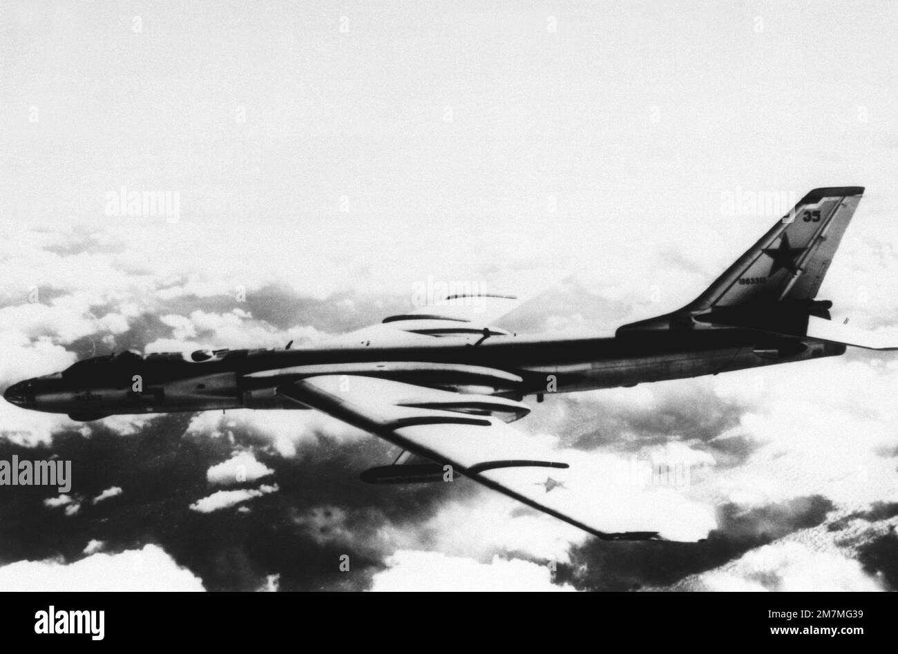 A left side view of a Soviet Tu-16 Badger bomber aircraft in flight ...