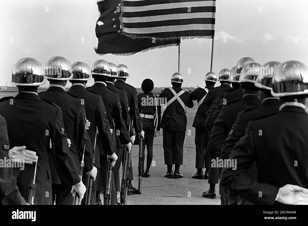An Air Force honor guard waits for the arrival of a C141 Starlifter aircraft carrying the