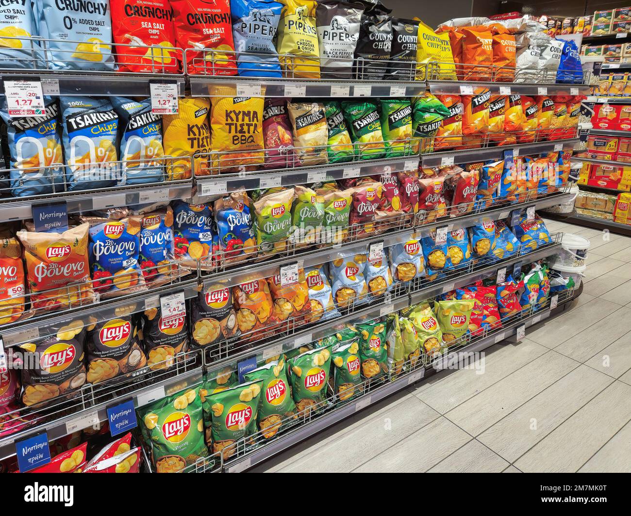 Potato chips on sale at the supermarket. Store interior with various