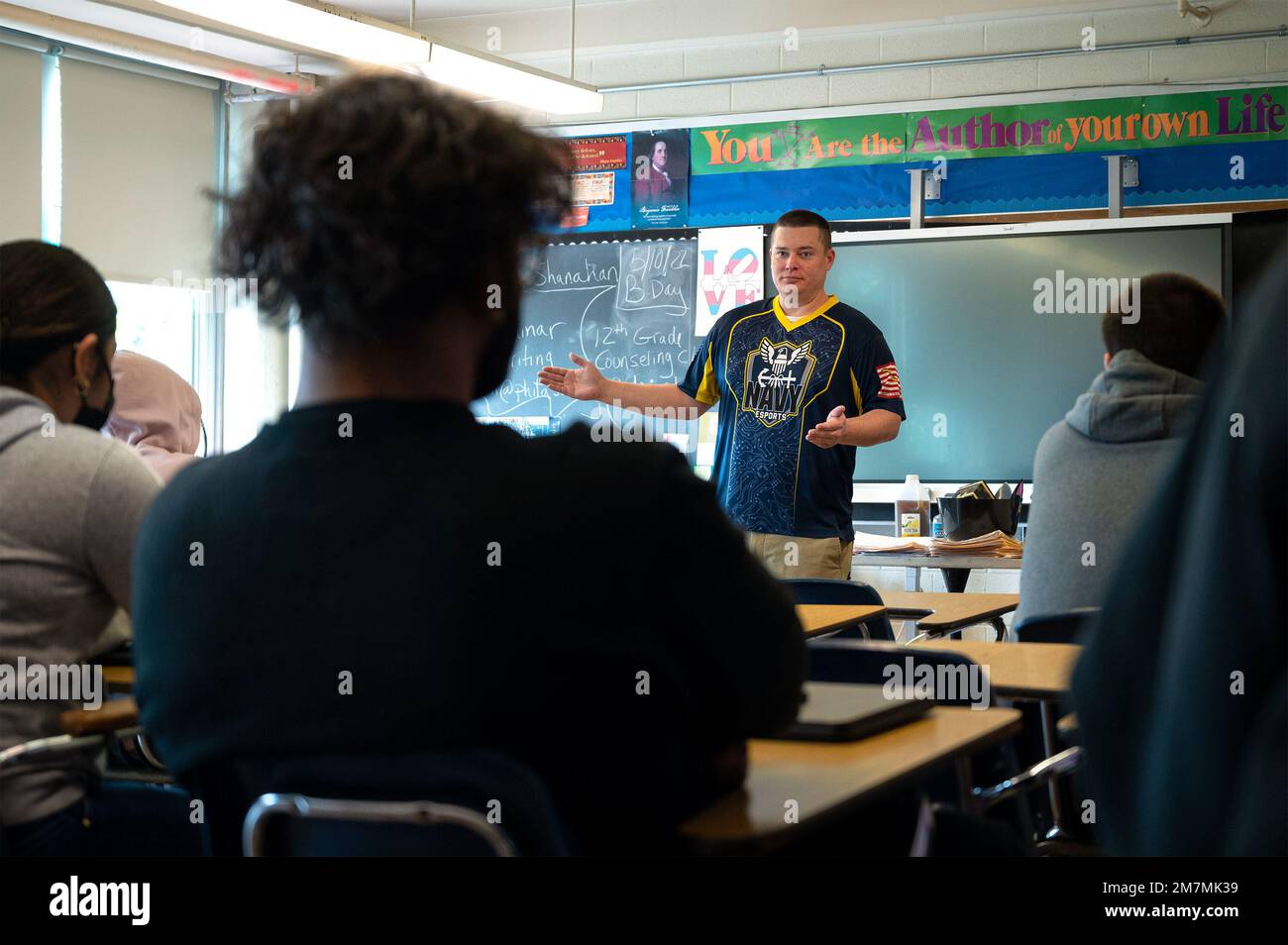 220511-N-WF272-1209 PHILADELPHIA (May 11, 2022) U.S. Navy Chief Electronics Technicians (Navigation) Michael Cox, a native of Annapolis, Md., a member of the Goats and Glory Navy eSports team, speaks to George Washington High School students during a Navy Promotional Day (NPD) Philadelphia, May 11, 2022. The purpose of an NPD is to build and sustain strategic networks with high schools, universities and colleges, and to promote Navy awareness within diverse and under-represented communities while building a pool of Science, Technology, Engineering, and Mathematics (STEM) talent, and showcasing Stock Photo