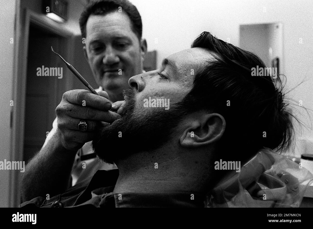 SSGT Ernest Witt, a hygienist at the main base dental clinic, cleans ...