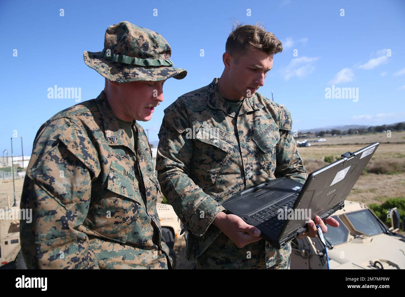 U.S. Marine Corps Cpl. Tucker Hager, left, and Cpl. Casey Grindle, both satellite operators with Communications Section, 13th Marine Expeditionary Unit Command Element, Receive Marine Corps wideband satellite communication expeditionary system data during the Deploying Group Systems Integration Testing at Marine Corps Base Camp Pendleton, California, May 11, 2022. DGSIT is a command and control and command post focused exercise designed to validate the Command, Control, Communications and Computers systems and procedures of the MEU and all major supporting elements prior to more intensive pre- Stock Photo