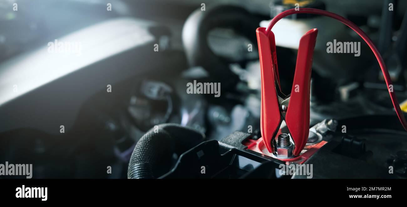 charging cable on car battery. banner with copy space Stock Photo