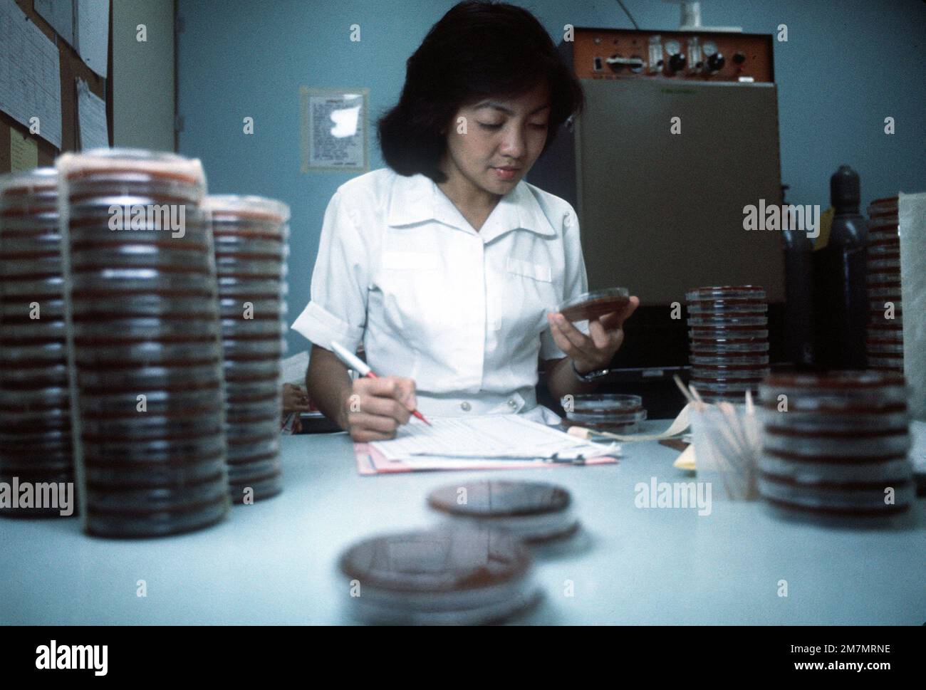 Adeluisa Cokee, a laboratory technician, measures antibiotic