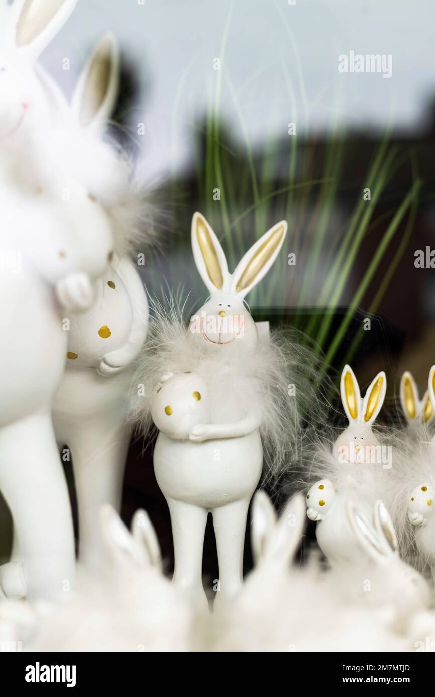 White Easter bunnies with feather collars in shop window Stock Photo