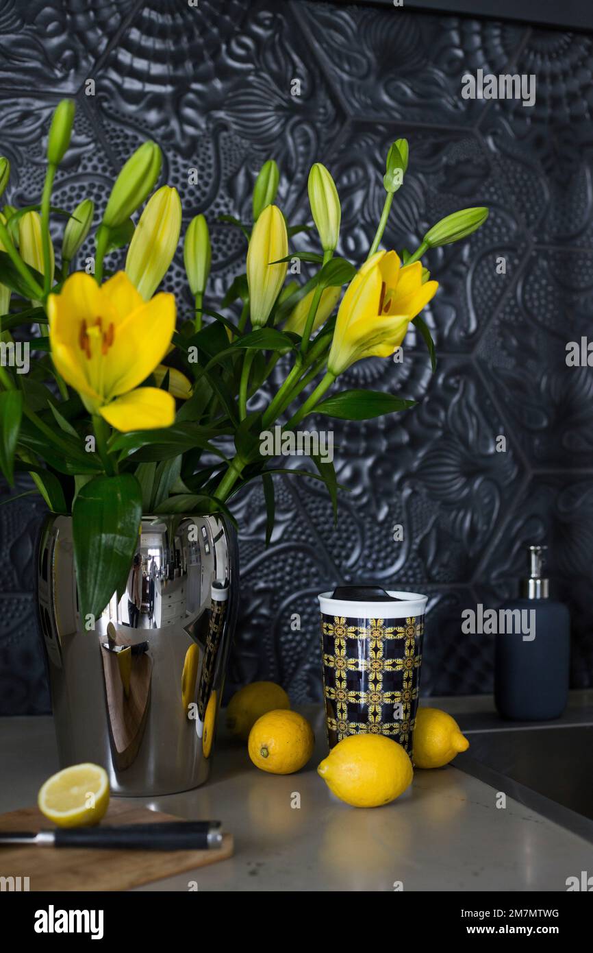 Still life with bouquet of yellow flowers and lemons Stock Photo - Alamy