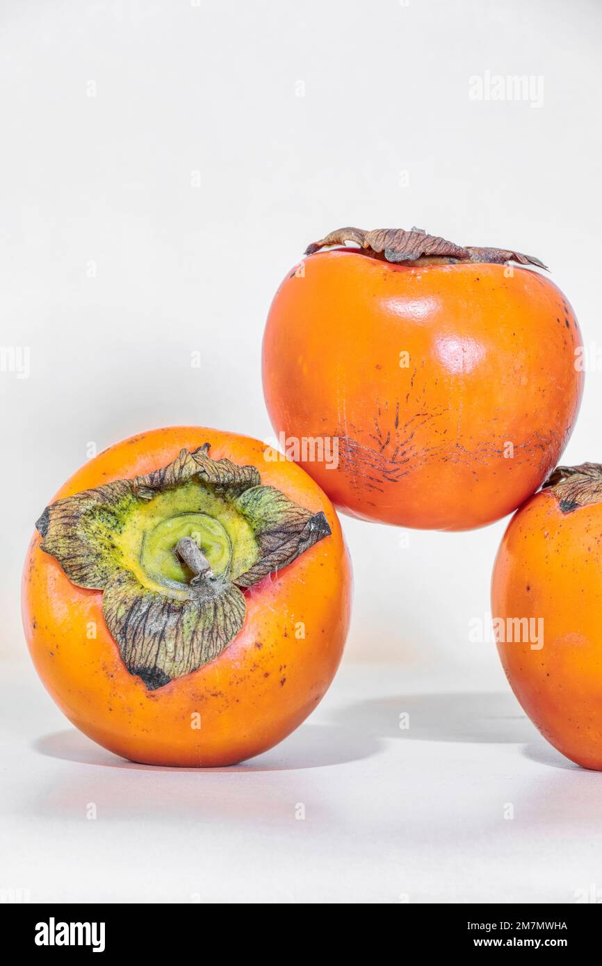 Diospyros kaki, Persimmon, seasonal fruit isolated on white background Stock Photo