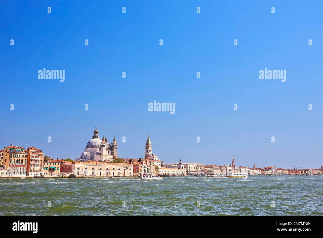 Directly on the Grand Canal is the baroque church of Santa Maria della Salute, built from 1631 by Baldassare Longhena, consecrated in 1687, not far from it the Doge's Square and the free-standing bell tower Campanile di San Marco Stock Photo