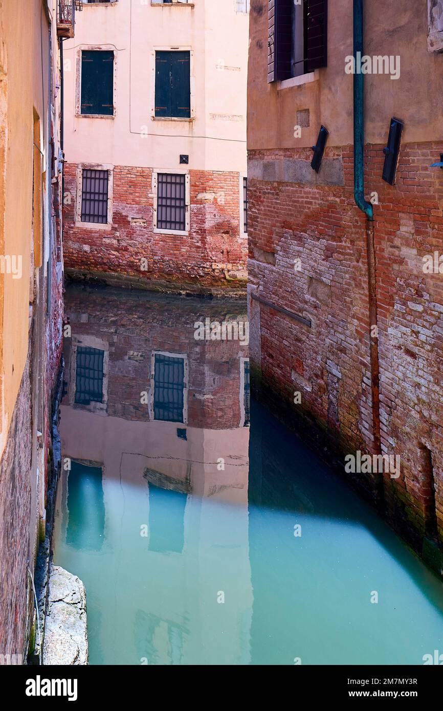 Houses in water built in Venice, canal, water reflection Stock Photo
