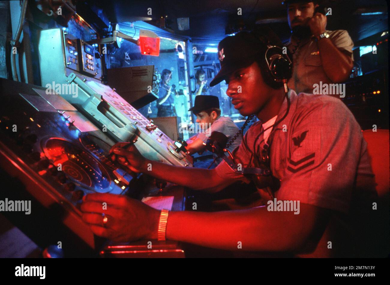 Crewmen monitor equipment in a shipboard Combat Information Center (CIC ...