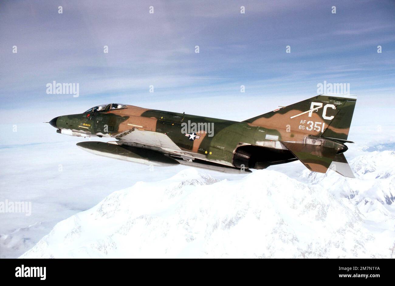 An air-to-air left side view of an F-4E Phantom II aircraft over Mount McKinley. The aircraft is assigned to the 21st Tactical Fighter Wing, Elmendorf Air Force Base, Alaska. Base: Mount Mckinley State: Alaska (AK) Country: United States Of America (USA) Stock Photo