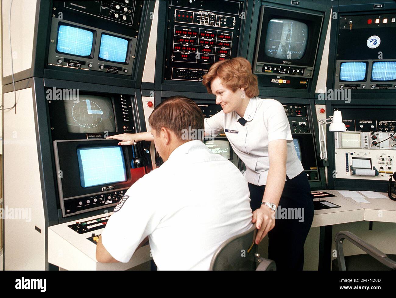 Technicians monitor the display and control consoles of the ground