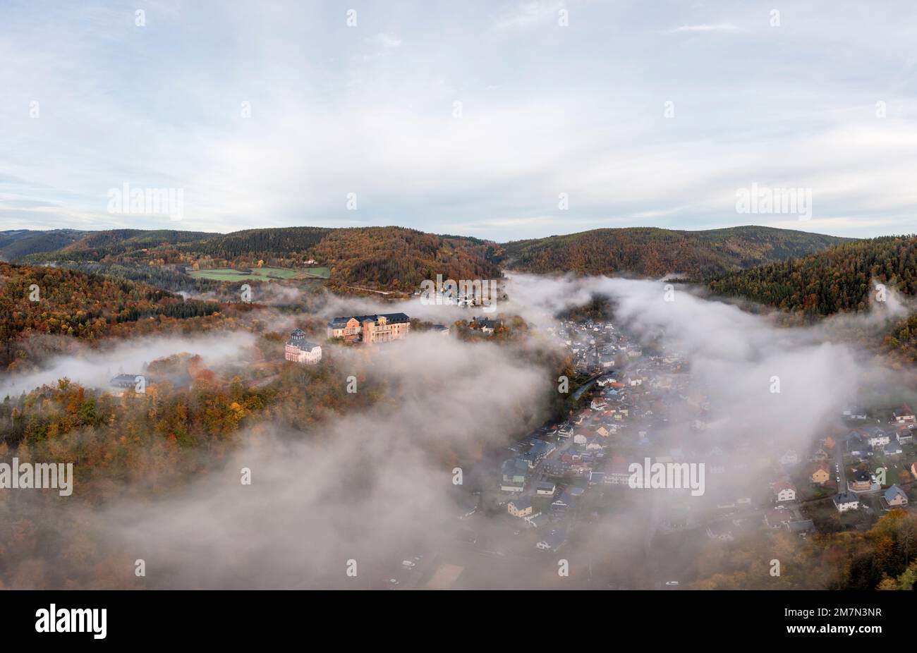 Germany, Thuringia, Schwarzburg, castle, place is partly under fog cover, mountains, forest, morning light, aerial photo Stock Photo