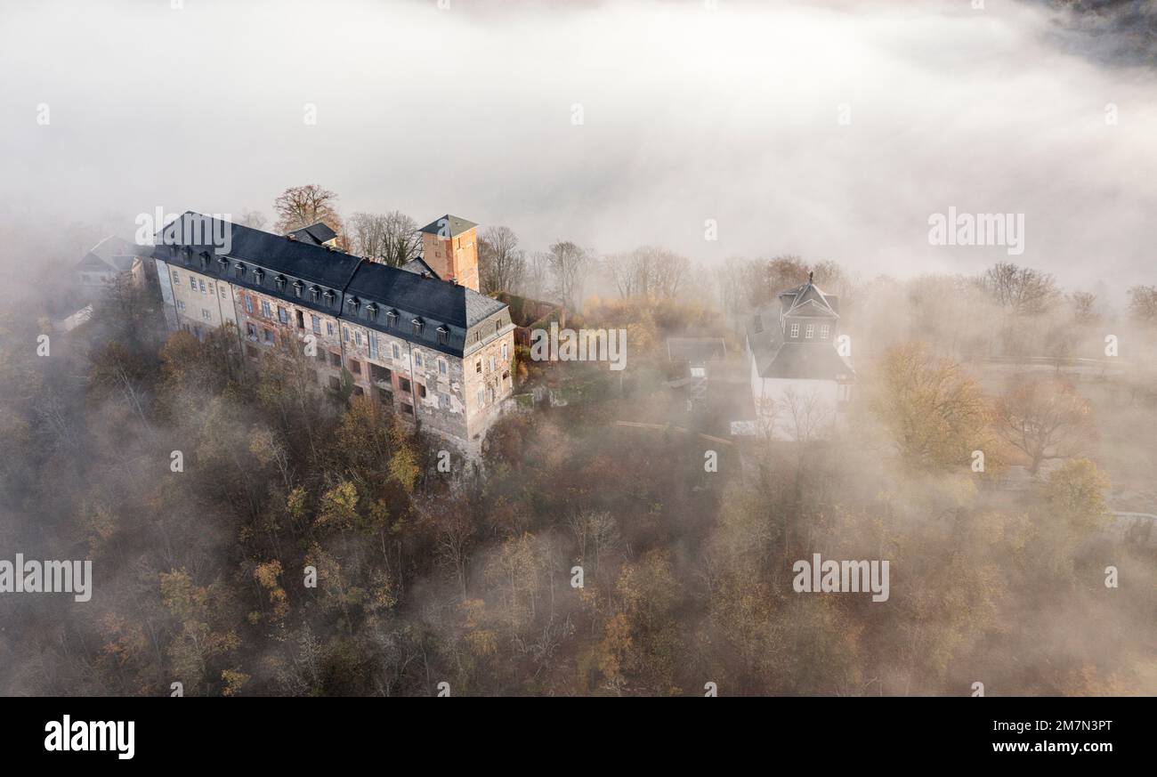 Germany, Thuringia, Schwarzburg, castle ruin, former baroque castle, imperial hall (right), valley fog, oblique view, aerial view Stock Photo