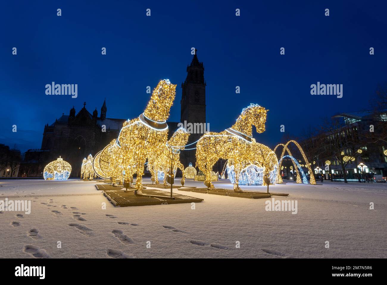 Snow covered cathedral square with the cathedral, glowing horse sculptures, glowing Christmas balls, Christmas world of lights, Magdeburg, Saxony-Anhalt, Germany Stock Photo
