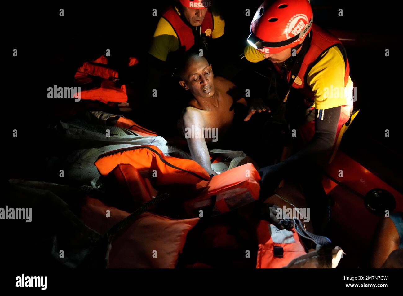 A migrant is rescued by members of the Spanish NGO Open Arms during a ...