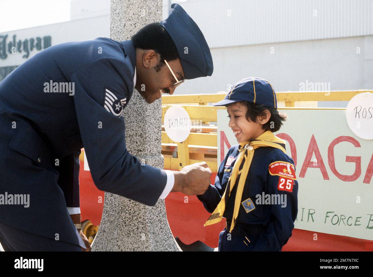 MASTER Sgt. Gary Kelly, a member of the Non-Commissioned Officers Academy Graduates Association (NCOAGA), meets cub scout Freddie Rodriguez. Base personnel helped handicapped scouts participate in the annual National Orange Show Parade. Base: Norton Air Force Base State: California (CA) Country: United States Of America (USA) Stock Photo