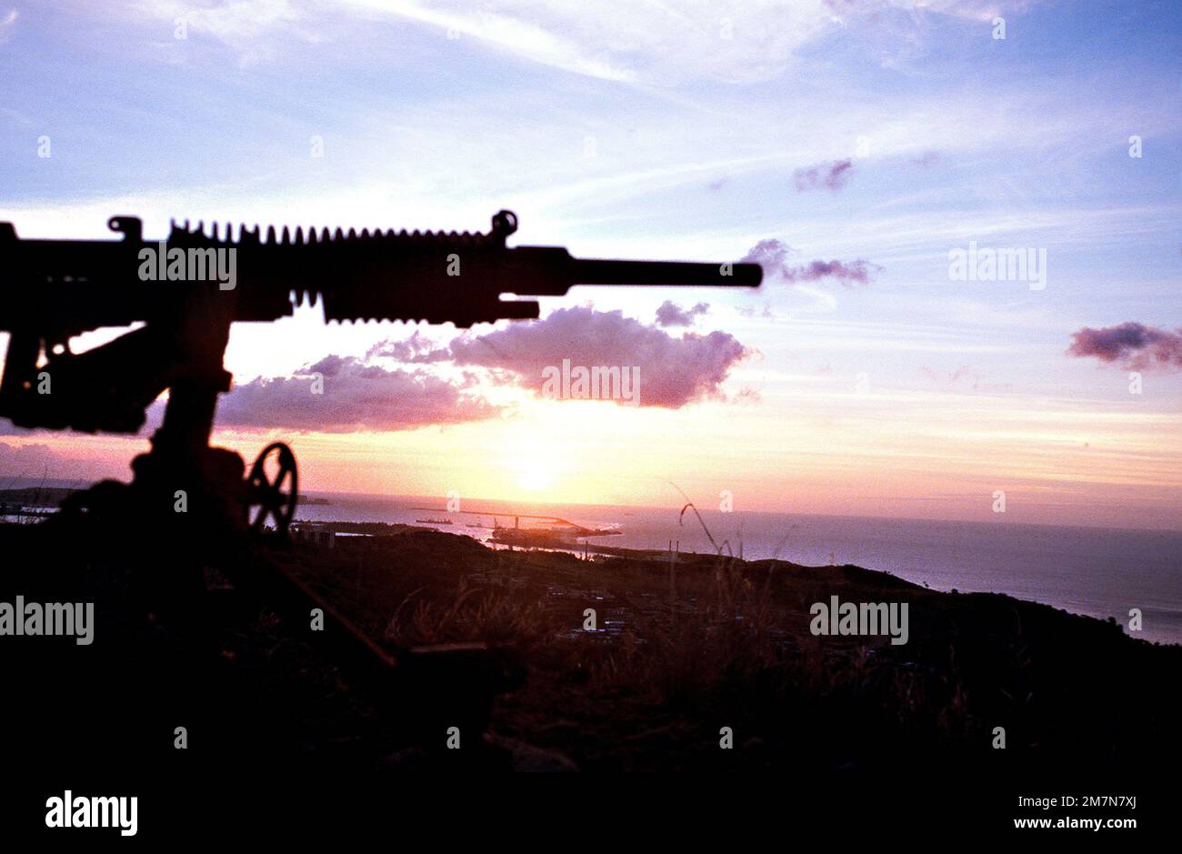 A World War II Japanese machine gun is silhouetted against the setting sun. Base: Fonte Plateau Country: Guatemala (GTM) Stock Photo