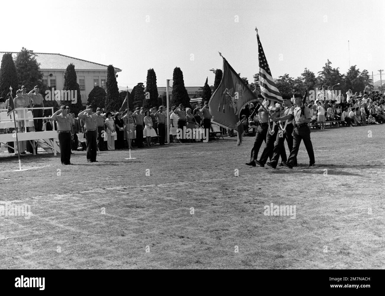 A Marine color guard passes in review during change of command ceremonies for COL Ralph D. Miller who is relieved by COL Speed F. Shea as commanding officer of the Marine Corps Air Station. COL Shea is on the far left side of the photograph. Base: Marine Corps Air Station,Iwakuni Country: Japan (JPN) Stock Photo