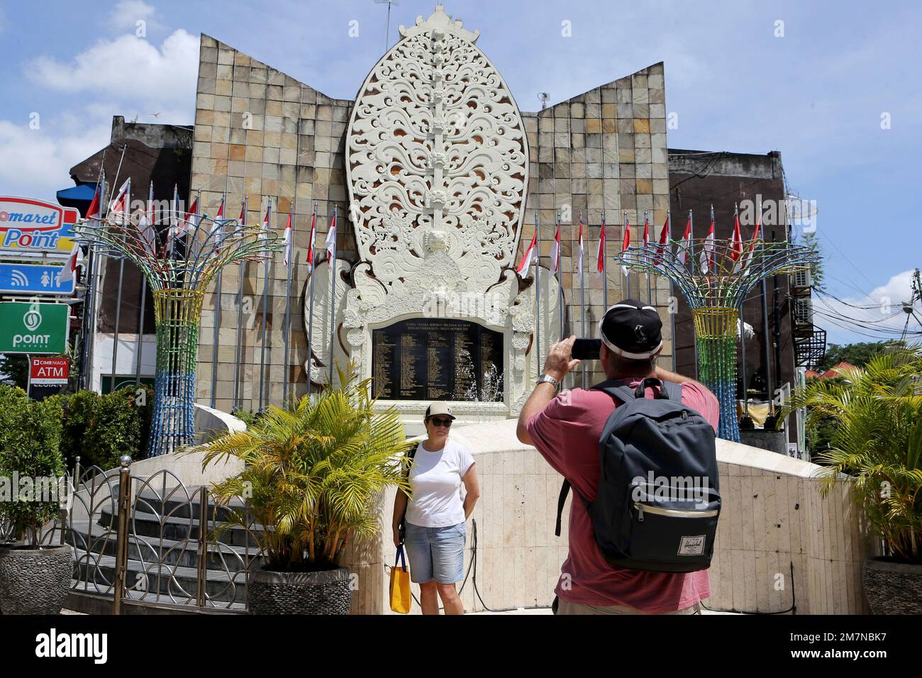 Foreign tourist take photographs at the Bali Bombing Memorial Monument