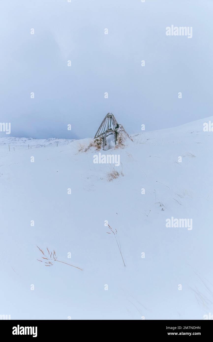 Old teepee in the snow on Magerøya, Norway Stock Photo