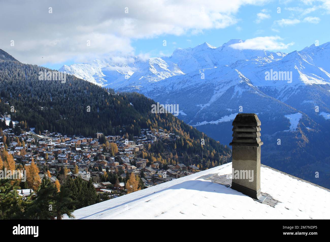 View of snow covered Swiss alps in autumn over the ski resort town of Verbier, Valais, Switzerland. Travel landscape of Swiss chalet overlooking alps Stock Photo