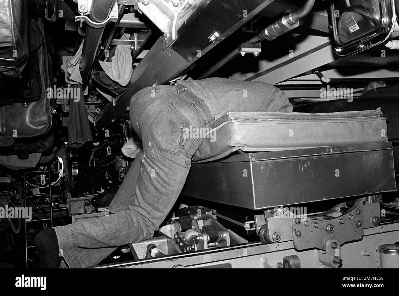 A crewman aboard the attack submarine USS Bonefish (SS-582) climbs into his bunk during exercise Unitas XX. Subject Operation/Series: UNITAS XX Base: Talcahuano Country: Chile (CHL) Stock Photo