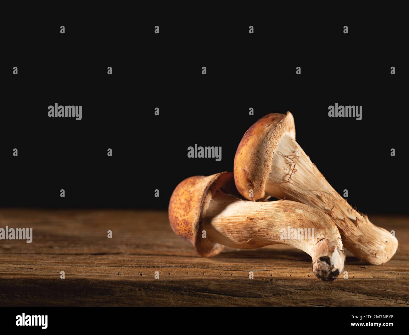 pine mushrooms on an old chopping board Stock Photo Alamy