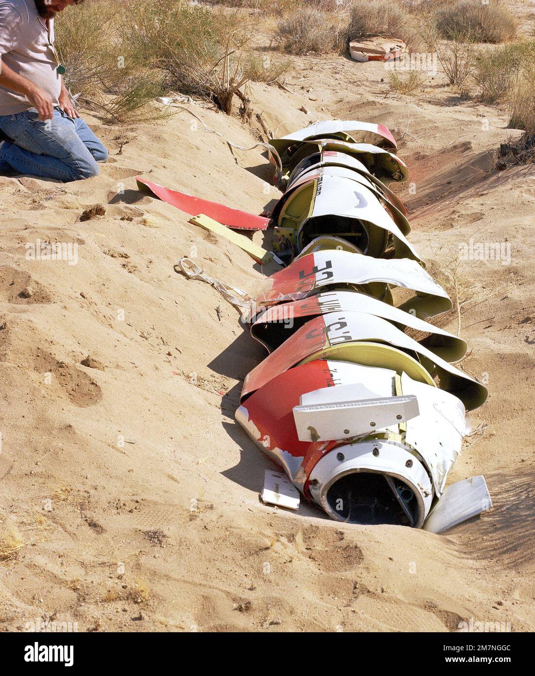 A close-up view of a damaged AGM-109 Tomahawk air-launched cruise missile on the ground after impact. Country: Unknown Stock Photo