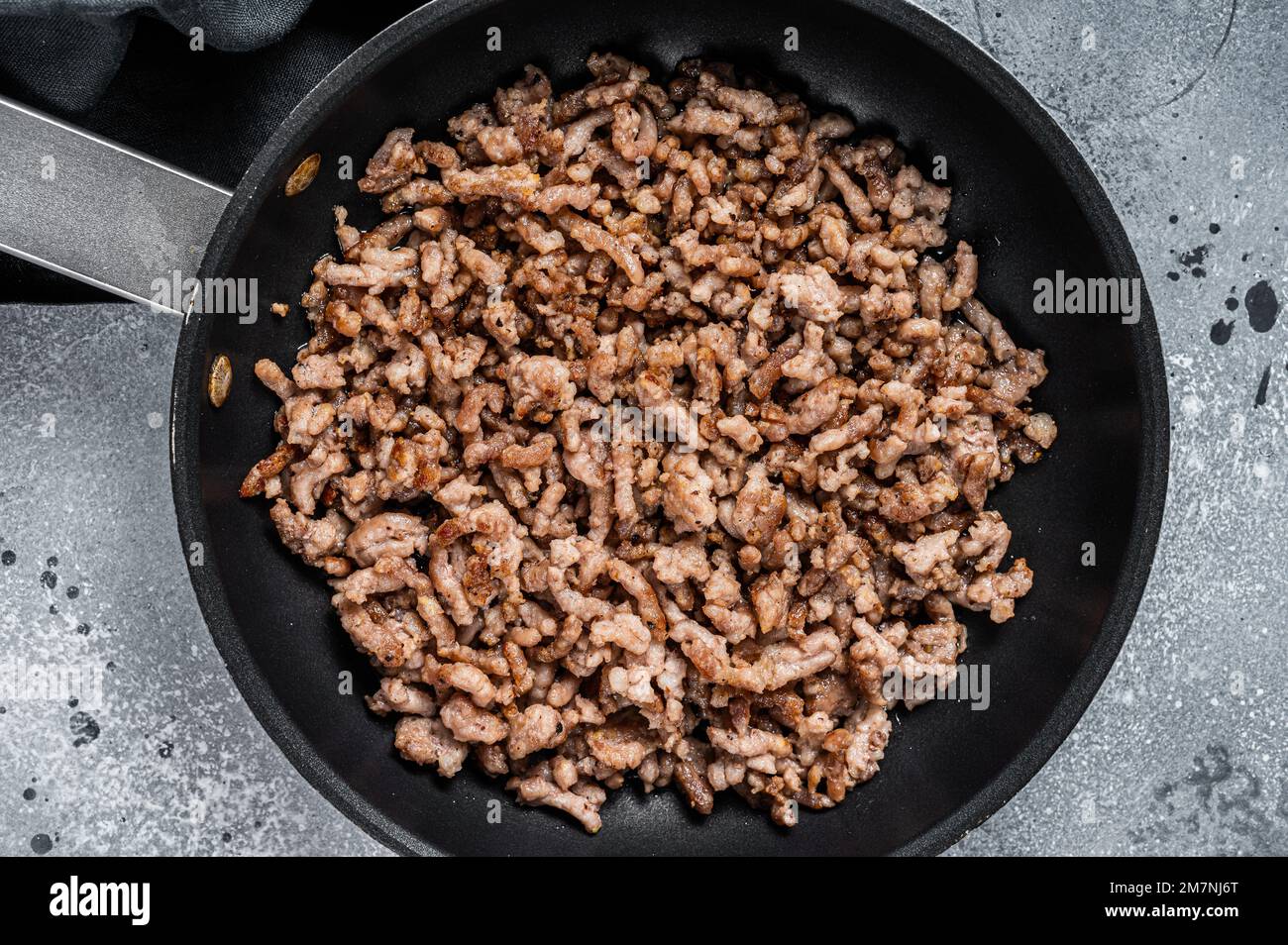 Pan fried minced meat to Italian pasta. Gray background. Top view Stock