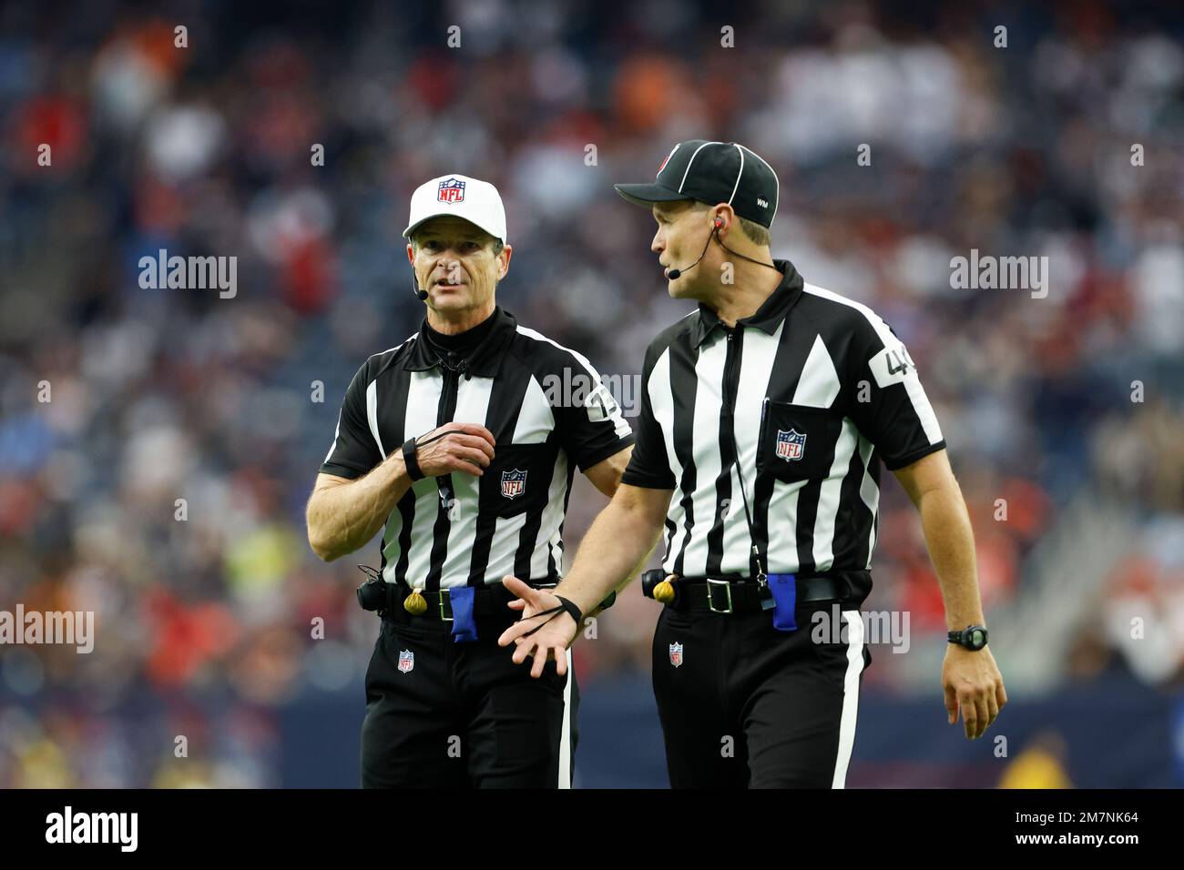 Referee Land Clark (130) and line judge Brian Bolinger (40) chat during