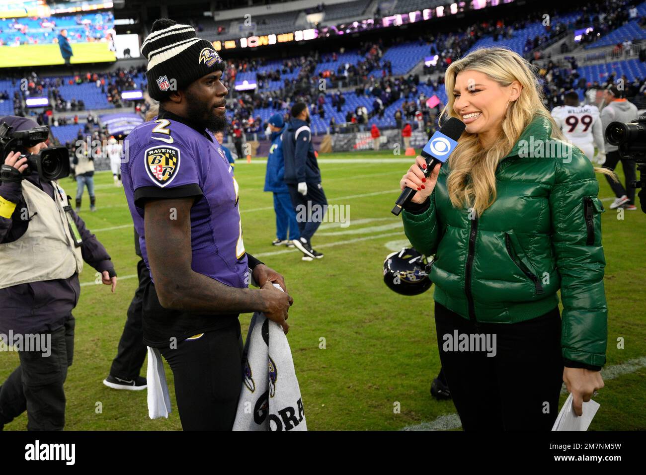 CBS sports sideline reporter Melanie Collins, right, meets with Baltimore  Ravens quarterback Tyler Huntley (2) after