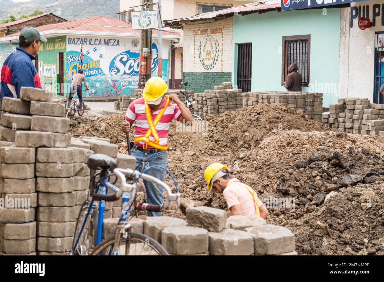 Men who commute by biicycle to job sites work on the Jinotega water system in 2014. Stock Photo