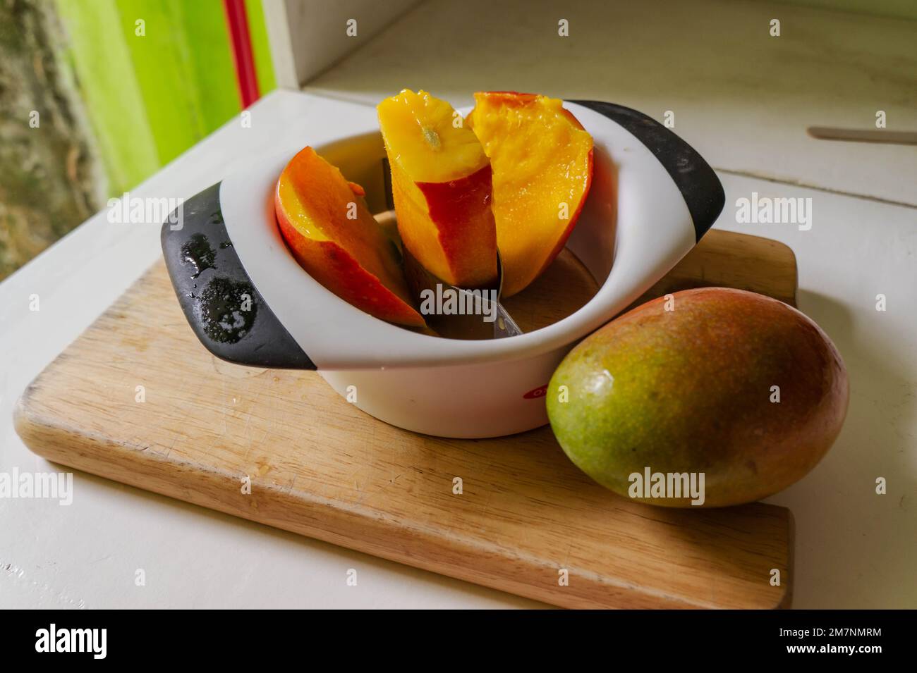 Mango deseeder cutting a mango in Nicaragua Stock Photo