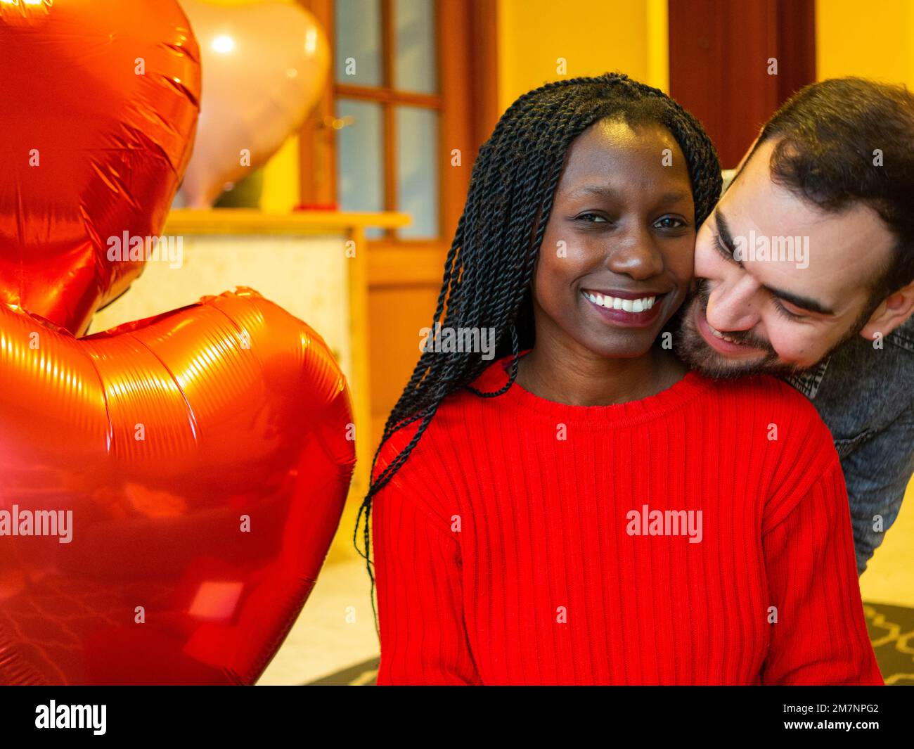 portrait of an interracial couple hugging while enjoying valentines day Stock Photo