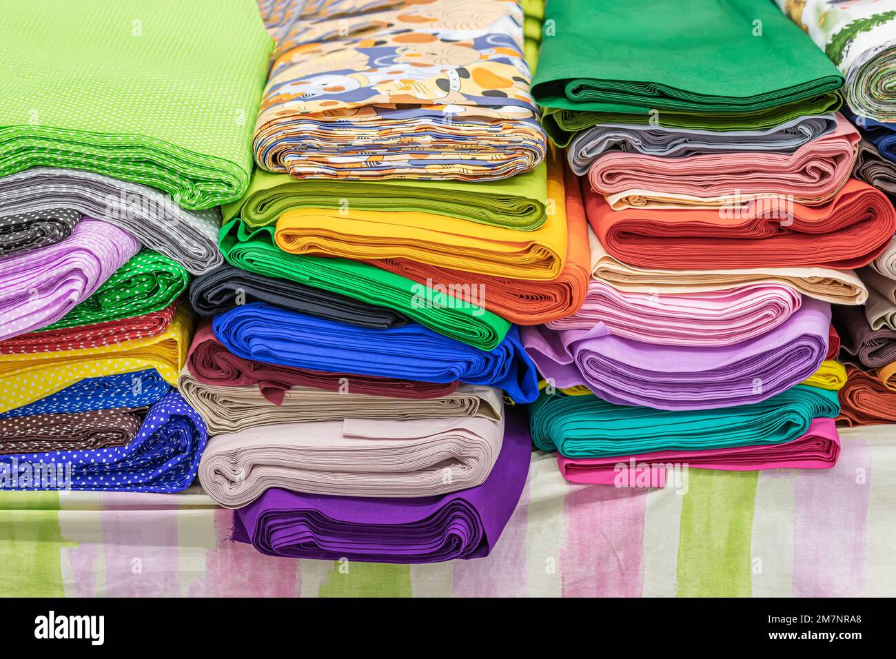 Colored textile or fabric in factory shop, store, choice of textiles for needlework and hobbies Stock Photo