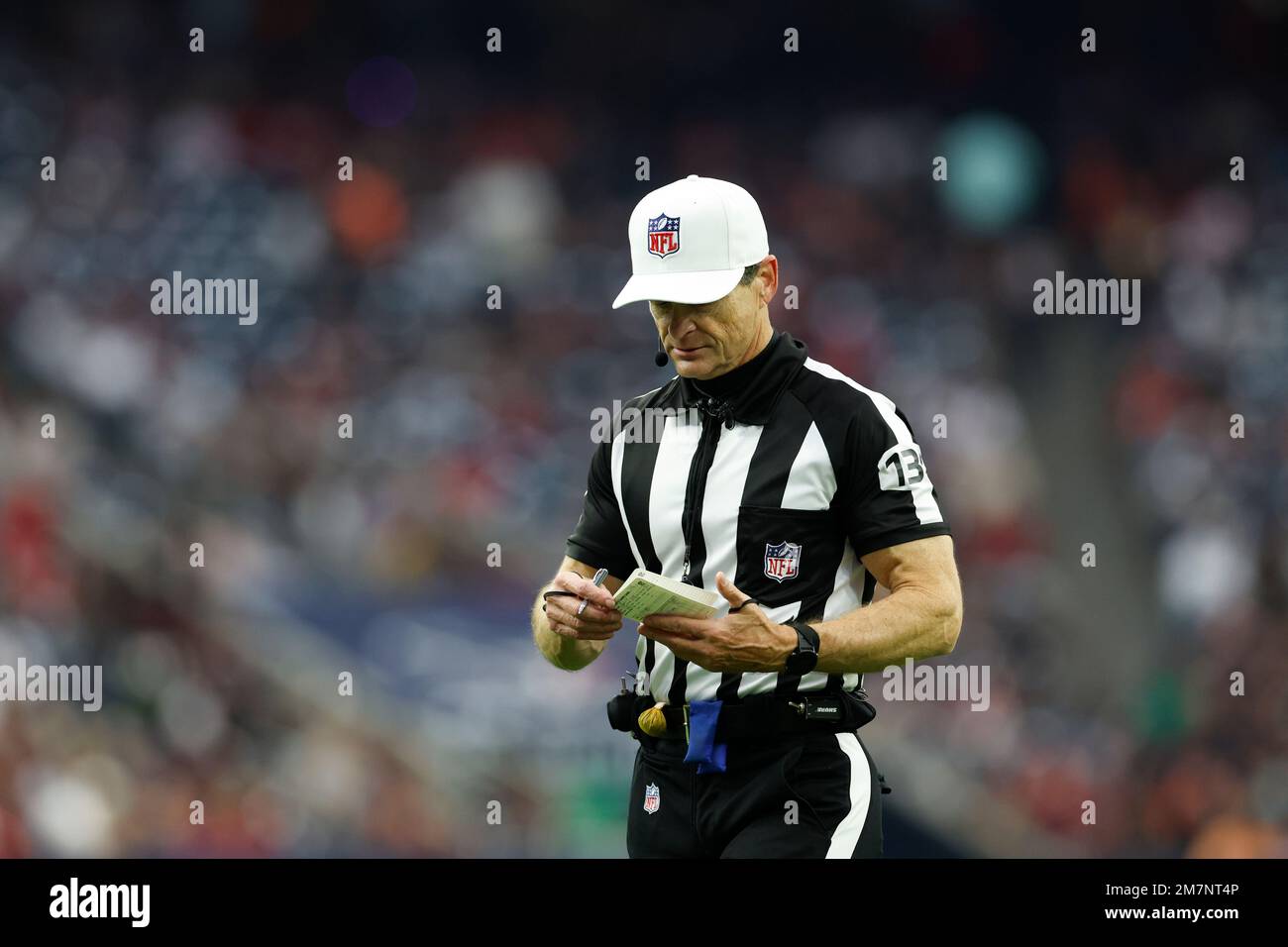 Referee Land Clark (130) makes notes during an NFL football game